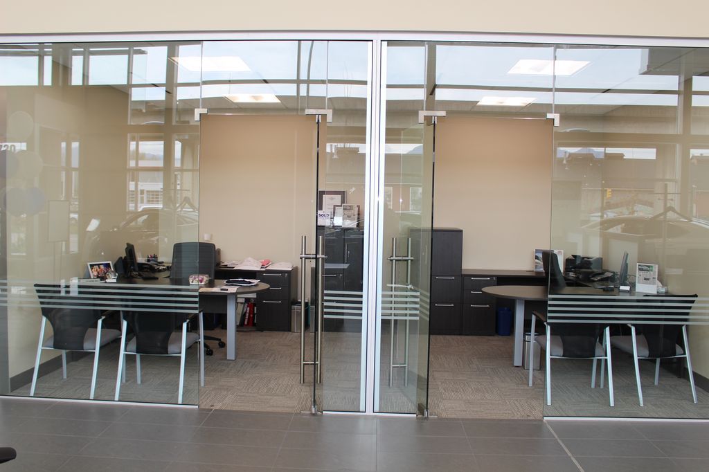 Glass walls for interiors in a Canadian car dealer with Unica hydraulic hinges.